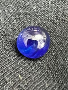 a blue stone sitting on top of a carpet