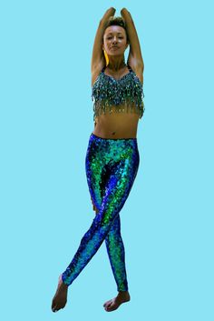 Mermaid disco sparkle pants for Women and Men. Our custom made sequin leggings are made by hand-sewing each sequin and a tiny bead individually. It's the only way to ensure the material will stretch and fit exactly around your legs and curves. Made for maximum visual impact, total comfort, and durability, these are a statement piece for your festival / rave / party wardrobe. A festival dream outfit, also suitable for professional pole dancers, circus performers, dancers and costume makers. And, Fitted Sequin Fabric For Festivals, Sequin Bottoms For Festival And Party Season, Party Season Sequin Bottoms, Sequin Disco Bottoms For Costume Party, Party Sequin Stretch Leggings, Glamorous Fitted Festival Bottoms, Glamorous Fitted Bottoms For Festival, Stretch Bottoms For Party And Festival, Glamorous Blue Sequined Pants