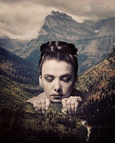 a woman with her hands on her face in front of a mountain range and forest