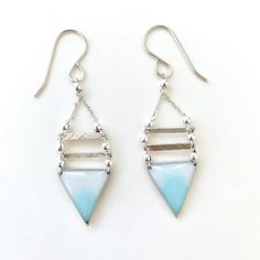 These Ombré Triangle Earrings are hand formed out of 14k gold filled or sterling silver metal. Two hammered metal bars connected above the triangle. Each earring is filled with white and turquoise resin creating an ombré effect.No two earrings are alike, as the resin is hand mixed and varies from piece to piece. Your necklace will be one of a kind.My Geometría Collection is an expression of my love for structure and geometry. I form and shape each piece by hand. •••••••••••••••••••Approximate Ea Sterling Silver Triangle Earrings For Pierced Ears, White Hammered Sterling Silver Earrings, Nickel Free Triangle Sterling Silver Earrings, Nickel-free Triangle Sterling Silver Earrings, Unique Triangle Sterling Silver Jewelry, Sterling Silver Triangle Jewelry With Matching Earrings, Nickel-free Triangle Sterling Silver Jewelry, Silver Triangle Jewelry With Ear Wire, Handmade Triangle Sterling Silver Jewelry