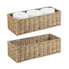 two wicker baskets with candles in them on a white background, one is empty and the other has three rolls of toilet paper