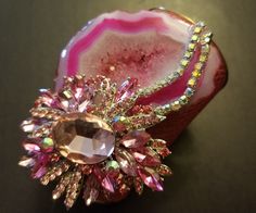 OOAK Wearable Art Cuff. A hot pink, freeform, druzy agate hosts gorgeous freeform pink agate jewel and two rows of aurora borealis rhinestones. Embellishments measure 4.5" x 3.5". The cuff is a faux pink snake print. Cuff has a gold metal interior and edge. Cuff is 4" at the widest point and tapers to narrower curve on your inner forearm. Will best fit wrists up to 7". Pink Gemstone Jewelry For Evening, Pink Rhinestone Costume Jewelry, Pink Crystal Brooch Jewelry, Pink Crystal Jewelry Brooch, Pink Crystal Jewelry With Stones, Unique Rhinestone Jewelry Gift, Unique Rhinestone Jewelry For Gifts, Dazzling Pink Jewelry For Party, Unique Pink Jewelry With Stones