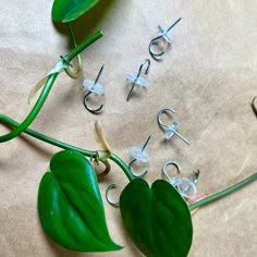 the letters are made out of metal wire and green leafy plants with leaves attached to them