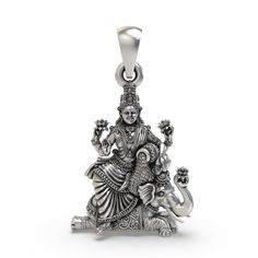 Enhance your spiritual journey with our Silver Lakshmi Maa Pendant. Expertly crafted from high-quality sterling silver, this pendant features a detailed depiction of Lakshmi Maa, the revered Hindu goddess of wealth, prosperity, and abundance. Handcrafted with exceptional care, this pendant serves as both a beautiful piece of jewelry and a powerful symbol of divine blessings. Ideal for daily wear or special occasions, it embodies the essence of prosperity and grace. Key Features: Sterling Silver: Lakshmi Maa, God Pendant, Goddess Of Wealth, Divine Blessings, Prosperity And Abundance, Goddess Pendant, Hindu Goddess, Sacred Symbols, Classy Jewelry