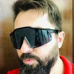 a bearded man with sunglasses on his face