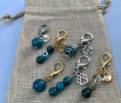 several charms are sitting on a piece of burlap fabric next to each other