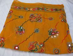 Pattern - embroidered sequin scarf. Ideal for - women/ girls. Occasion - formal or casual. Fabric - cotton. It has an embroidered floral pattern all over. This piece is from the Kutchh area of Gujarat. It is hand-painted and embroidered. Color - On a yellow background, embroidery is done with different colored threads and mirror sequins. Plastic sequins are used because they are lightweight. Size - 40 x 84 inches(approx). Care - gentle hand wash. For more such scarves please visit- https://www.e Yellow Cotton Dupatta With Embroidered Border, Multicolor Embroidered Cotton Dupatta For Summer, Summer Cotton Dupatta With Multicolor Embroidery, Gold Embroidered Cotton Dupatta, Yellow Bollywood Dupatta For Spring, Yellow Embroidered Cotton Dupatta, Handmade Cotton Dupatta, Traditional Cotton Shawl For Spring, Summer Bohemian Dupatta With Mirror Work