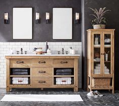 a bathroom with double sinks and two mirrors on the wall next to a wooden cabinet