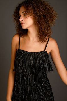 This suede mini dress is perfect for a night out on the town. With its sleeveless design, fringed detail, and embellished accents, this dress is sure to turn heads. Whether you're hitting up a club or going to a fancy dinner, this mini dress is a great choice. You'll look and feel fabulous in this amazing dress. Fringed Mini Dress For Night Out, Fringe Mini Dress For Date Night And Party Season, Party Season Fringe Mini Dress For Date Night, Club Mini Dress With Fringe For Party Season, Summer Mini Dress With Rhinestone Fringe For Night Out, Night Out Mini Dress With Beaded Fringe, Glamorous Beaded Fringe Mini Dress For Night Out, Glamorous Mini Dress With Beaded Fringe For Night Out, Glamorous Beaded Fringe Mini Dress For Evening