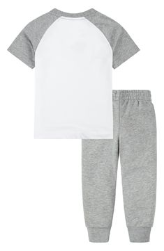 Give your kid sporty style with this logo printed T-shirt and joggers set constructed from a soft cotton blend. Set includes T-shirt and joggers 60% cotton, 40% polyester Machine wash, tumble dry Imported Nike Sporty T-shirt For Loungewear, Nike Cotton T-shirt For Loungewear, White Relaxed Fit Playwear Sets, White Cotton Activewear, Nike Casual Cotton Sets, Nike White Cotton Joggers, Casual Nike Cotton Sets, White Cotton Nike Joggers, Cotton Sport Sets With Graphic Print