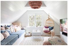 a living room filled with furniture and a hanging chair next to a tv on top of a wooden table