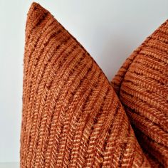 a close up view of a brown pillow on a white surface