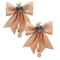 two bows with pine cones and bells on them