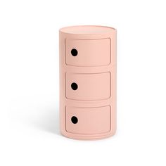 the three drawers are pink with black dots on them and one drawer has four holes in it