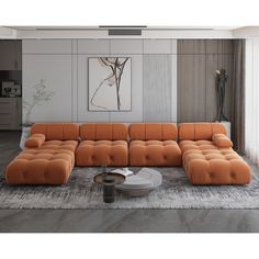 an orange sectional sofa sitting on top of a rug in front of a wall mounted painting