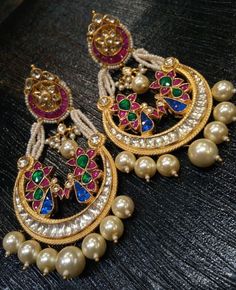 *It's Handmade Milticolor Indian Ethnic Kundan Earrings. *It's made from Silver n Copper with Multi color Kundan Stones Settings with 22k gold Plating as shown in picture. *It it Pure Ethnic Look with Antique Touch and 3 inches Long. *Our all jewelry is made from semiprecious stones and beads. *WARRANTY: ITS GENUINE HANDMADE JEWELRY AND WE ARE GIVING LONG LIFE WARRANTY FOR OUR ALL ITEMS. All of our Kundan Jewelry is 100% handmade with ancient Kundan stone setting method using silver foils. It is Kundan Pearl Earrings For Festivals In Temple Jewelry Style, Traditional Multicolor Chandbali Hoop Earrings, Multicolor Chandbali Earrings With Intricate Design, Multicolor Chandbali Earrings With Cutdana, Traditional Kundan Pearl Earrings With Cutdana, Temple Jewelry Style Chandbalis With Cutdana, Heavy Temple Jewelry Pearl Earrings For Celebration, Multicolor Chandbali Hoop Earrings For Weddings, Temple Jewelry Pearl Chandbali Earrings With Meenakari