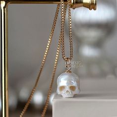 💀PEARLS: Genuine White Freshwater Pearl 💀SIZE: Ranging in size, from 10 to 11mm excluding the bail 💀NECKLACE : -14Kt Yellow Gold Filled - Box Chain 1mm 18 - 24 inches -925 Sterling Silver - Box Chain 1mm 18 - 24 inches -14K Yellow Gold - 1.2 mm Rounded Box Chain 18 inches 💀BAIL METAL: 14k Yellow Gold Filled 925 Sterling Silver 14k Yellow Gold 💀 BAIL SIZE: The gold-filled bail is 5 mm Sterling Silver bail is 5 mm. 14k gold bail is 5 mm Please contact me if you need to customize it. 💀 Authentic Metal Quality Guaranteed! Rest assured that all the metal qualities mentioned in the description are accurately represented. Occasionally, due to the small size of the product, a hallmark may not be stamped onto the item. You can verify the authenticity of the metal at any local jewelry store. W Luxury Skull Jewelry For Gifts, Luxury Skull Shaped Jewelry For Gift, White Skull Shaped Jewelry Gift, Pearl Skull, Carved Pearl, Fantasy Earrings, Gothic Pendant, Snake Jewelry, Vintage Jewelry Necklace