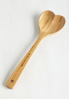 a wooden spoon sitting on top of a white table