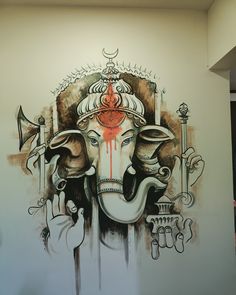 an elephant painted on the side of a wall with other things in it's mouth