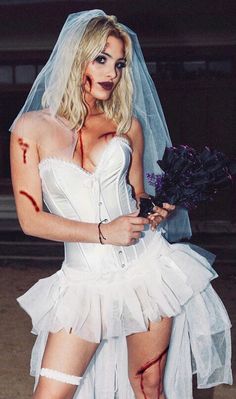 a woman dressed up as a zombie bride