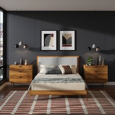 a bed sitting in a bedroom next to two framed pictures