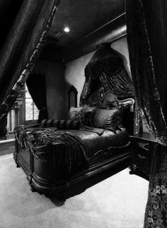 a black and white photo of a bed in a room