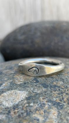 Silver stacking rings are great for everyday ware. This substantial silver bear ring is made with traditional silversmithing techniques and is a great gift for any nature lover. Perfect for both men and women and can be personalized with a stamp of your choice. DETAILS Material: sterling silver Band Thickness: 3.2 mm Available stamp images: shown in photo Bear Swirl Oak Leaf Antler Trinity Symbol Crow Horse Diamond Sizes: made to order in US ring sizes 6-17 Fabrication: 3 business days Shipping: Silver Thumb Rings For Women, Trinity Symbol, Bear Ring, Silver Ring For Men, Spirit Bear, Stamped Ring, Chunky Silver Rings, Thumb Rings Silver, Silver Bear