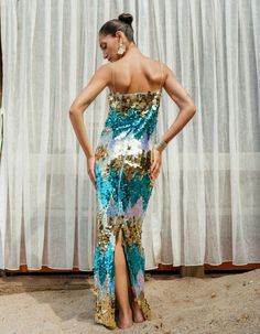 This „Dila“ dress is made from turquoise/gold hue toned sequins and has a collarbone-baring cut. Size & Fit Fits true to size Slightly loose Mid-weight, non-stretchy fabric Details & Care Sequins (100% Polyester) Lining: Satin (95% Polyester / 5% Lycra) Concealed zip fastening Dry Clean SIZE SHOULDER CM BUST CM WAIST CM HIP CM SLEEVE LENGTH CM 34 37 84 64 93 57 36 38 88 68 97 58 38 39 92 72 101 59 40 40 96 76 105 60 42 41 100 80 109 61 44 42 104 84 113 62 Summer Sequin Maxi Dress For Gala, Summer Gala Sequined Maxi Dress, Summer Sequined Maxi Dress For Night Out, Summer Gala Maxi Dress With Sequins, Gold Party Dress With Contrast Sequin, Glamorous Gold Dress With Contrast Sequin, Gold Sequin Maxi Dress For Party, Gold Maxi Sequin Dress For Party, Embellished Sequin Maxi Dress For Summer