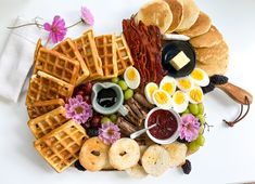 a white plate topped with waffles and other foods