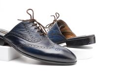 Wear these Blue Brogue Wingtip Mules to stand out from the crowd. This wingtips full brogue oxford mule combines a classic Oxford style with decorative brogueing and wingtip detailing. Introducing our exceptional Blue Hand Burnished two tone patina wingtip brogue oxford Loafer Mule/Slipper for men with close lacing round toe. This pair Stand out for its sleek and elegant design, superior craftsmanship, use of luxurious materials, and its ability to add a touch of sophistication to both formal an Half Shoes, Backless Loafers, Mens Loafers, Bespoke Shoes, Wingtip Oxford, Label Machine, Heel Caps, Blue Hand, Rubber Heels