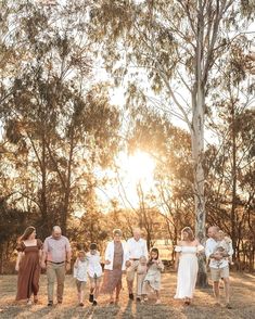 a family walking through the woods at sunset