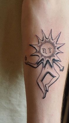 a person with a sun tattoo on their arm