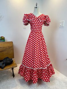 1940's dress / 40s dress / 1940s puff sleeve dress / 1930s dress / 30s dress / vintage puff sleeve dress / 31.5" waist  This is a floor length, puff sleeve, beauty that  was professionally made in the late 30's or early 40's. She is absolutely magnificent. She is made of a red and white polka dot cotton and is trimmed in white lace with navy blue piping around the collar. Her sleeves are puffy and she has a very full ruffle hem. This beauty moves when you walk due to the volume of the skirt. I enjoy this beauty without a belt, but I could resist trying her with one too. The back of her skirt is extra full with the lace running higher in back, creating a larger ruffle panel across the back. So beautiful! Measurements provided are flat and have been doubled. side metal zipper. Bust 40" Waist Fitted Vintage Dress With Ruffles And Puff Sleeves, Retro Puff Sleeve Dress With Ruffles, 1950s Ruffled Vintage Dress, 1950s Vintage Dress With Ruffles, 1950s Style Vintage Dress With Ruffles, Fitted Cottagecore Dresses For Vintage Events, Spring Retro Puff Sleeve Dress, Retro Dresses With Ruffles And Fitted Bodice, Retro Ruffled Dress With Fitted Bodice