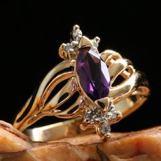 🖤 DESCRIPTION This ring has such a regal look! The gorgeous, natural amethyst is the focal point, and the stone is surrounded by three points on the top and bottom, adorned with sparkling, natural diamonds. The open face has stunning ribbon detailing in the gold. Lovely gift for any occasion! 🖤 SPECIFICS Size (Approximate): 5 1/2 (Sizable by a Professional Bench Jeweler) Metal Type: Solid 14k Gold Total Item Weight: 2.8 Grams 🖤 SHOP Check out similar pieces in our shop:  https://www.etsy.com/shop/ArtofNatureVintage Message us for a viewing appointment. Our brick and mortar store is in Grand Ledge, MI. 🖤 SHIPPING Domestic First Class shipping is always free!  Options to upgrade your shipping are available upon check out. Depending on the amount, your package may, or may not, require sig Luxury Vintage Gold Amethyst Ring, Luxury Vintage Amethyst Jewelry, Bench Jeweler, Vintage Gold Jewelry, Diamond Ring Vintage, Jewellers Bench, Pretty Accessories, Amethyst And Diamond Ring, Open Face