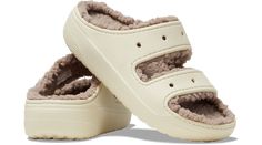 The new Classic Cozzzy Sandal features a soft, fuzzy liner, style-forward heightened outsoles and two upper straps that offer enhanced foot security. Seven holes on each sandal allow for maximum personalization with Jibbitz™ charms, while Croslite™ foam construction keeps them light and easy to wear.  Classic Cozzzy Sandal Details:    Warm, fuzzy liner  Two-strap upper  Style-forward heightened outsoles  Incredibly light and fun to wear  Croslite™ foam footbeds for lasting comfort  Customizable with Jibbitz™ charms (sold separately)  Iconic Crocs Comfort™: Lightweight. Flexible. 360-degree comfort. Classic Cozzzy Sandal, Saltwater Sandals, High Heel Slippers, Crocs Classic Clogs, Water Sandals, Muck Boots, Heel Slippers, Stylish Sandals, Flat Espadrilles