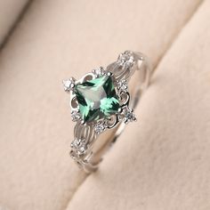 This ring features a 6*6 mm princess cut lab green sapphire. Customization is available. It is made by hand, and it will take about 7 days to finish the ring after your payment is completed. Main stone: 6*6 mm princess cut lab green sapphire Main stone weight:1.37 ct Metal type: 925 Silver Accent stone: CZ Customization is available, just fee free to contact me, it is free to engrave inside the ring, it is free, you can leave a ntoe with your order, but it will be great no more than 13 letter. A Princess Cut Emerald Ring, Emerald Silver Engagement Ring, Rings With Green Stones, Stone Settings Jewelry, Cute Promise Rings, Ring Princess Cut, Green Sapphire Engagement Ring, Green Sapphire Ring, Cute Engagement Rings