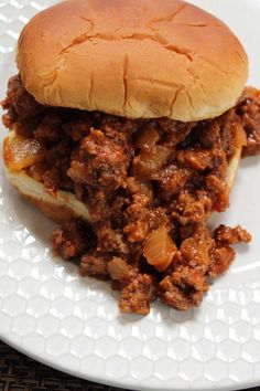 a sloppy joe sandwich on a white plate