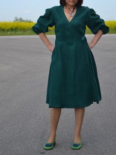 This natural linen wrap dress is a beautiful style dress with functional side pockets and puffy sleeve design. Dress is made from soft, lightweight linen, it is designed for comfort and style. With 3/4 sleeves, loose fit, with a belt, It's the perfect dress for any casual occasion, practical and comfortable. The sleeves bottom part is with an elastic strap. Check your measurements in the size chart before ordering!! THE Fabric is made from 100% Lithuanian linen. The color might be slightly diffe Fitted Green Linen Midi Dress, Knee-length Linen Puff Sleeve Dress, Fall Linen Midi Dress With V-neck, Spring Linen Dress With Surplice Neckline, Short Sleeve Linen Midi Dress For Fall, Spring Linen Dress With Gathered Sleeves, Linen Midi Dress With Gathered Sleeves, Fitted Linen Midi Dress With Pockets, Knee-length Linen Midi Dress With Gathered Sleeves