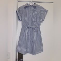 Collared Dress With Blue And White Stripes And Buttons. Blue Summer Shirt Dress For Daywear, Casual Cotton Mini Dress With Tie Waist, Blue Cotton Shirt Dress For Summer, Casual Blue Shirt Dress With Tie Waist, Casual Blue Shirt Dress, Casual Mini Shirt Dress With Tie Waist, Blue Tie Waist Dress For Daywear, Blue Dresses With Tie Waist For Daywear, Blue Daywear Dress With Tie Waist