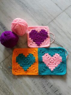 three crocheted squares with hearts on them