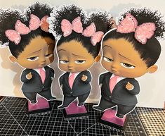 three little black girls with pink bows on their head and one is wearing a suit