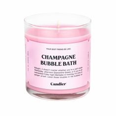 a pink candle with the words champagne bubble bath on it's label in front of a white background