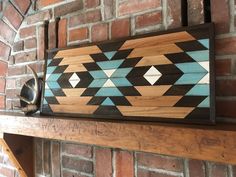 a wooden sign sitting on top of a brick wall next to a fireplace mantel