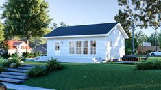 a small white house sitting on top of a lush green field