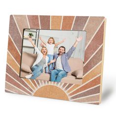 an image of a family with their hands up in the air on a wooden frame