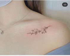 a woman's shoulder with a flower tattoo on it, and the back of her neck