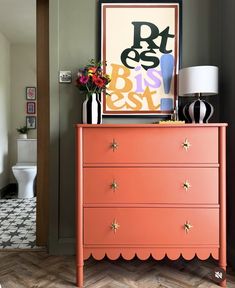 an orange dresser with gold stars on it