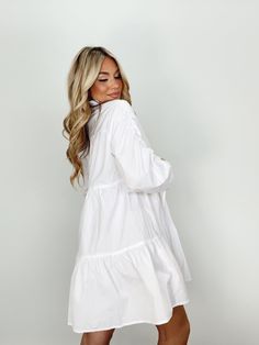 Indulge in luxury with our Collared Button Up Mini Dress. With its collared neckline, button closures, and ruched sleeves, this dress provides an elevated and trendy look. The mini and tiered design is perfect for any occasion, from brunch dates to elegant dinners. Its bright and versatile style is a must-have for your wardrobe, whether for a bridal event or a basic yet sophisticated look. Self 60% Cotton 40% Polyester Hand wash cold. Mini Dress With Gathered Sleeves For Daywear, Elegant Mini Dress With Gathered Sleeves For Day Out, Elegant Mini-length Tiered Dress With Ruffle Hem, Spring Smock Dress For Work, Knee-length Ruffled Shirt Dress For Day Out, Tiered Mini Dress For Daywear, Spring Chic Shirt Dress With Gathered Sleeves, Spring Shirt Dress With Ruffles For Brunch, Chic Spring Shirt Dress With Gathered Sleeves