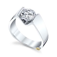 a white gold engagement ring with a round cut diamond in the center and yellow accents