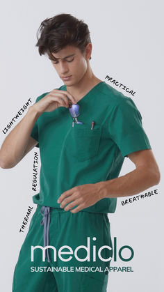 a man in green scrubs is holding his hand on his chest and looking down